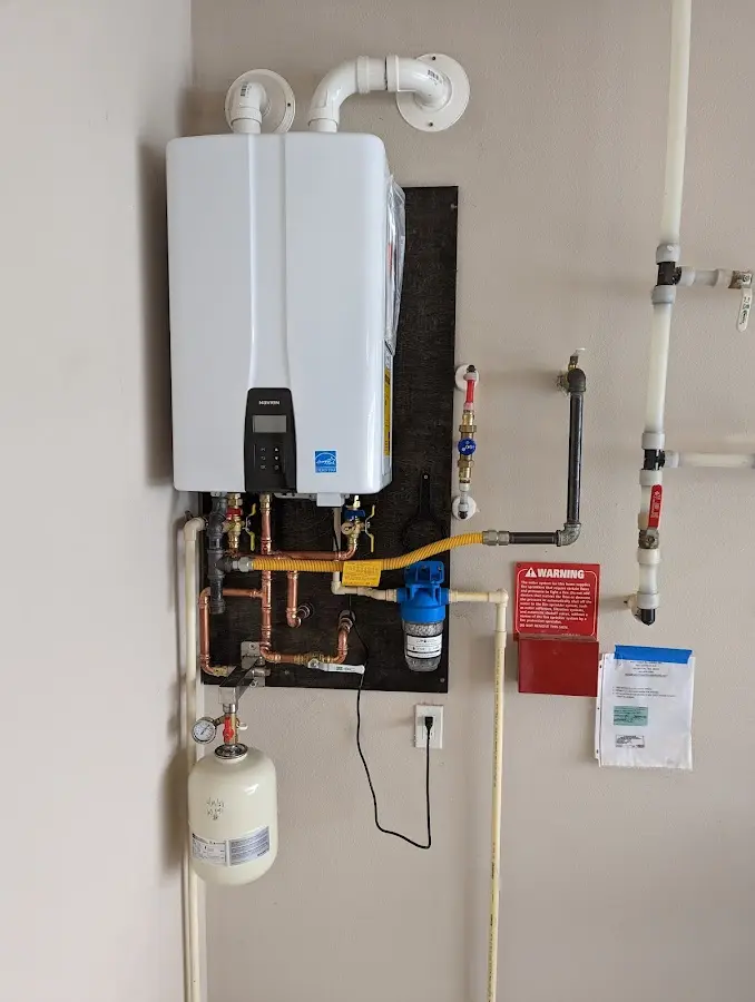 Professional plumber installing copper piping in a LaFayette home